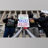 Demonstrators hold signs outside of the Kenosha County Courthouse during closing arguments in the Kyle Rittenhouse trial in Kenosha, Wisconsin, U.S., on Tuesday, Nov. 16, 2021. Rittenhouse, 18, is accused of homicide in the deaths of Joseph Rosenbaum and Anthony Huber, as well as attempted homicide for shooting Gaige Grosskreutz. Photographer: Christian Monterrosa/Bloomberg via Getty Images