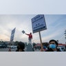 Protesters hold  up a signs, Friday, Nov. 19, 2021, in Los Angeles, following the acquittal of Kyle Rittenhouse in Kenosha, Wis.