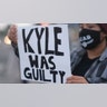 A protester holds up a sign, Friday, Nov. 19, 2021, in Los Angeles, following the acquittal of Kyle Rittenhouse in Kenosha, Wis.