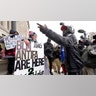 Emily Cahill, left, and Jamarcus Blaze, right, argue outside the Kenosha County Courthouse, Tuesday, Nov. 16, 2021 in Kenosha, Wis., during the Kyle Rittenhouse murder trial. Rittenhouse is accused of killing two people and wounding a third during a protest over police brutality in Kenosha, last year. (AP Photo/Paul Sancya)