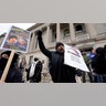 Protesters rally outside the Kenosha County Courthouse, Tuesday, Nov. 16, 2021, in Kenosha, Wis., during the Kyle Rittenhouse murder trial. Rittenhouse is accused of killing two people and wounding a third during a protest over police brutality in Kenosha, last year. (AP Photo/Paul Sancya)