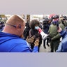 Protesters argue outside the Kenosha County Courthouse, Tuesday, Nov. 16, 2021, in Kenosha, Wis., during the Kyle Rittenhouse murder trial. Rittenhouse is accused of killing two people and wounding a third during a protest over police brutality in Kenosha, last year. (AP Photo/Paul Sancya)