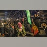 Demonstrators take a knee and have a moment of silence as they march on the Brooklyn Bridge, Friday, Nov. 19, 2021, in New York, following the acquittal of Kyle Rittenhouse in Kenosha, Wis.