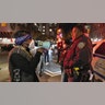 A demonstrator confronts an NYPD officer while marching on the street during a protest against the Kyle Rittenhouse not-guilty verdict near the Barclays Center in New York.