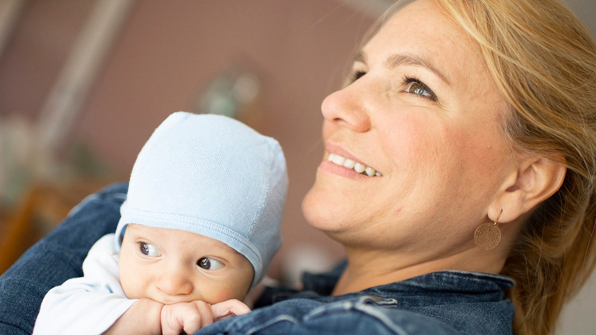 Mom smiles with baby