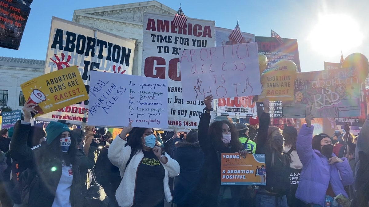 Pro and anti-abortion activists gather outside the Supreme Court.