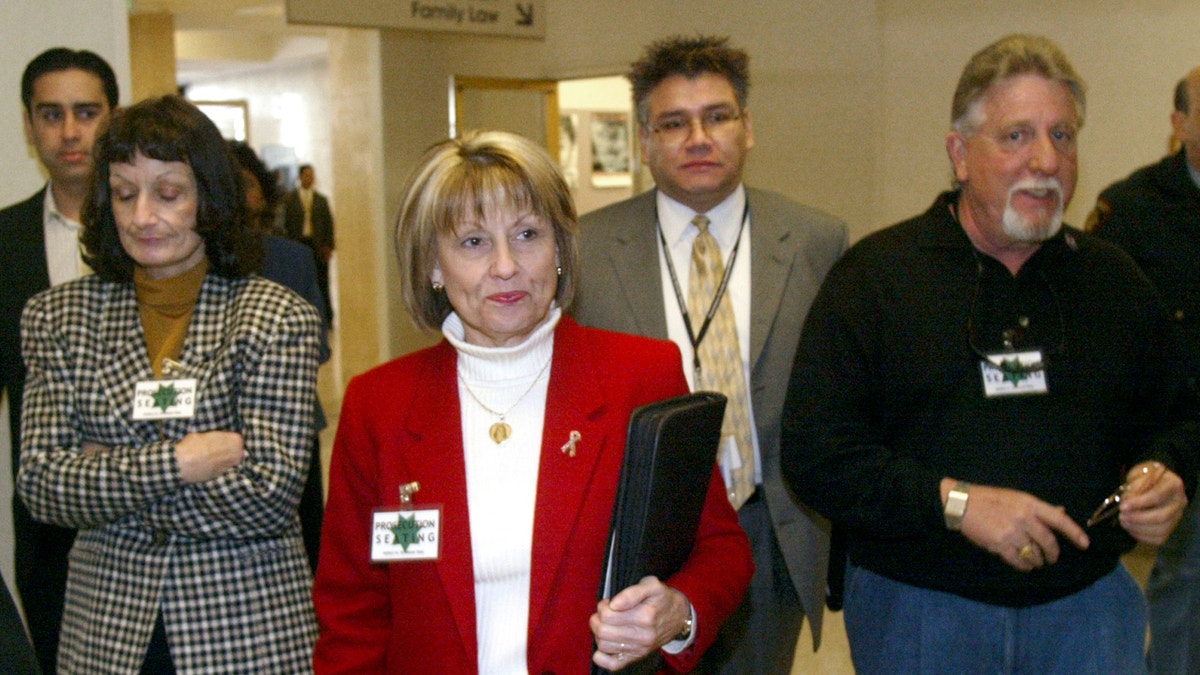 Sharon Rocha (C), mother of Laci Peterson, her son Brent Rocha (L) and her husband Ron Grantski (R) arrive at the courthouse in Redwood City February 17, 2004. Laci Peterson's husband Scott, is accused of murdering her and the couple's unborn son. REUTERS/POOL/John Green JDP