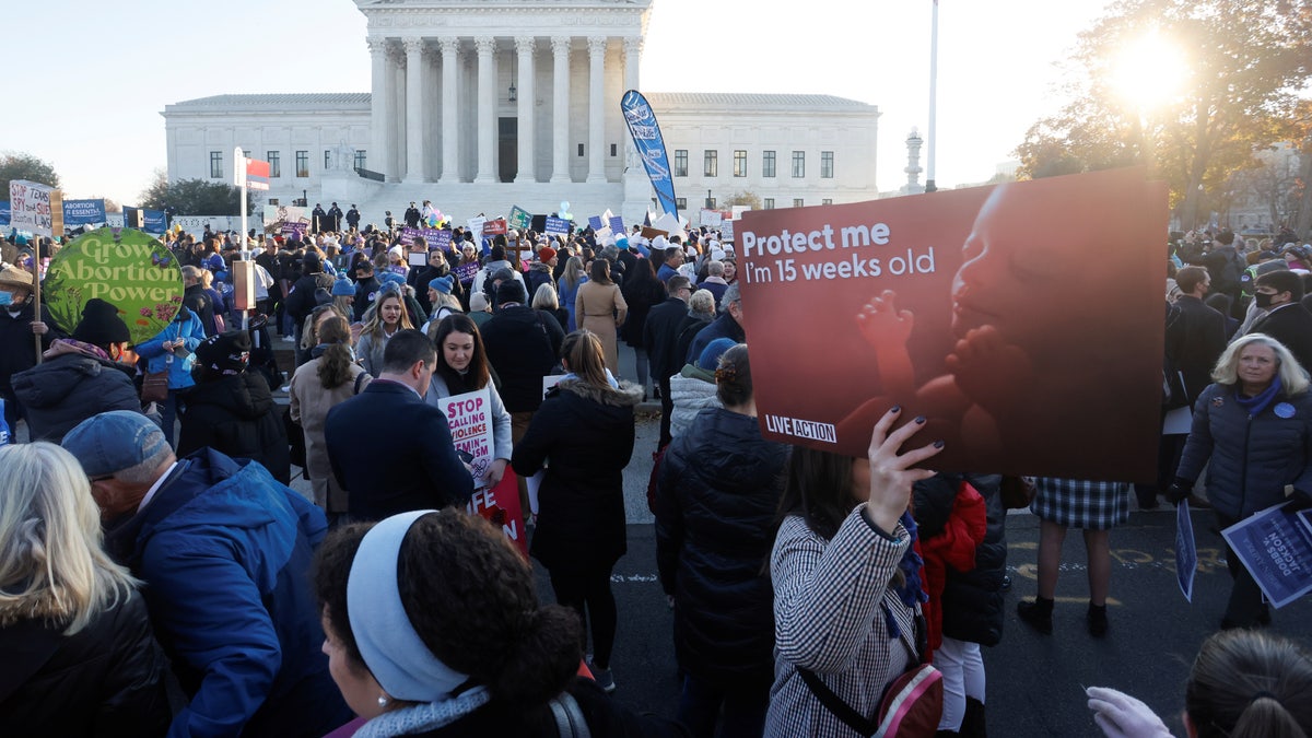 Anti-abortion and pro-abortion rights activists protest outside the Supreme Court building, ahead of arguments in the Mississippi abortion rights case Dobbs v. Jackson Women's Health, in Washington, U.S., December 1, 2021. REUTERS/Jonathan Ernst