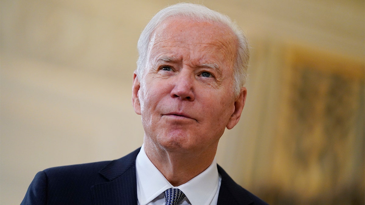 President Biden listens to a reporter's question after delivering remarks on the November jobs report in the State Dining Room of the White House, Friday, Dec. 3, 2021, in Washington.