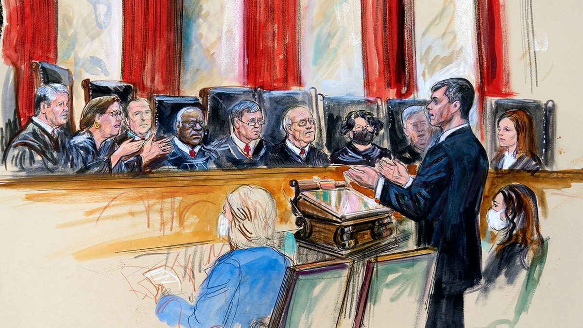 This artist sketch depicts Mississippi Solicitor General Scott Stewart, standing while speaking to the Supreme Court, Wednesday, Dec. 1, 2021, in Washington. Center for Reproductive Rights Litigation Director Julie Rikelman is seated right. Justices seated from left are Associate Justice Brett Kavanaugh, Associate Justice Elena Kagan, Associate Justice Samuel Alito, Associate Justice Clarence Thomas, Chief Justice John Roberts, Associate Justice Stephen Breyer, Associate Justice Sonia Sotomayor, Associate Justice Neil Gorsuch and Associate Justice Amy Coney Barrett. (Dana Verkouteren via AP)