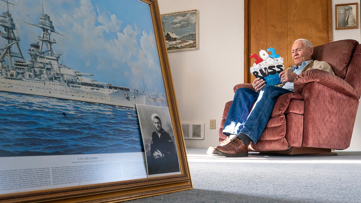 Pearl Harbor survivor and World War II Navy veteran David Russell, 101, reads a birthday card while talking about his time aboard the USS Oklahoma and his life after the war on Monday, Nov. 22, 2021, in Albany, Ore. (AP Photo/Nathan Howard)