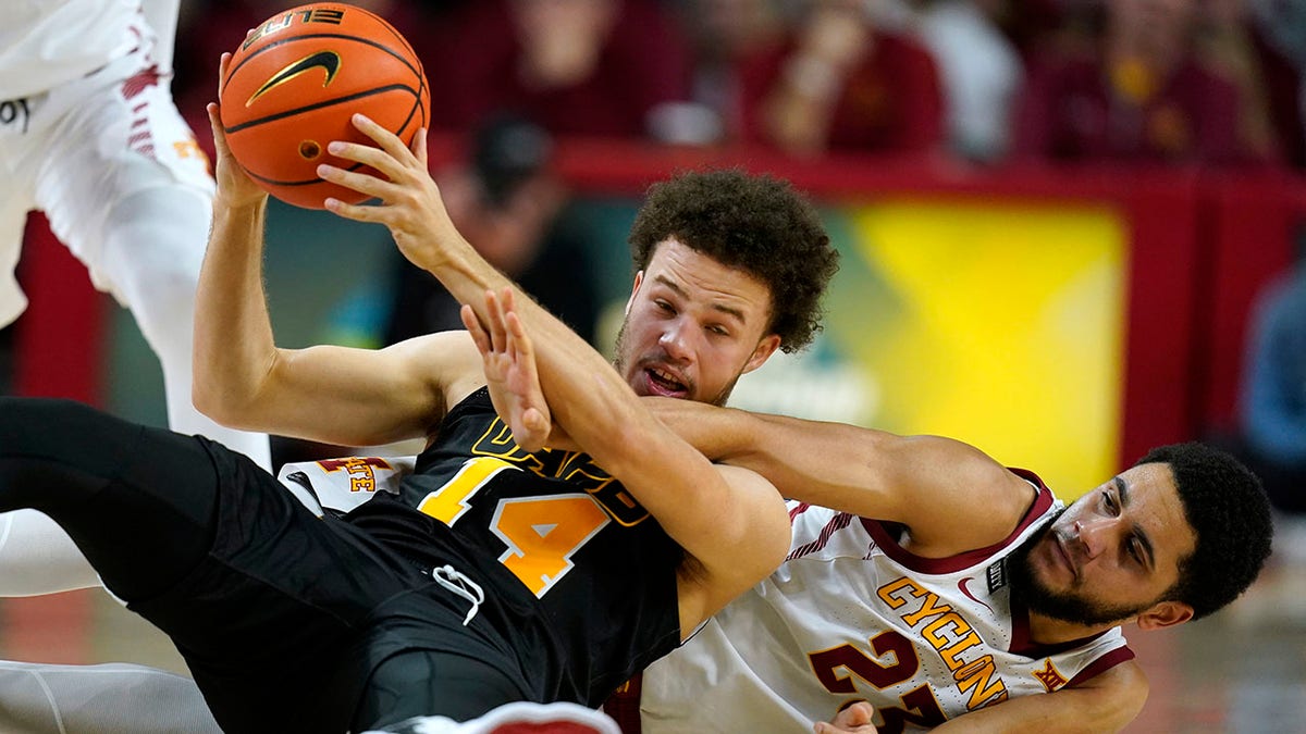 Iowa State guard Tristan Enaruna (23) tries to steal the ball from Arkansas-Pine Bluff guard Brahm Harris (14) during the first half of an NCAA college basketball game, Wednesday, Dec. 1, 2021, in Ames, Iowa.