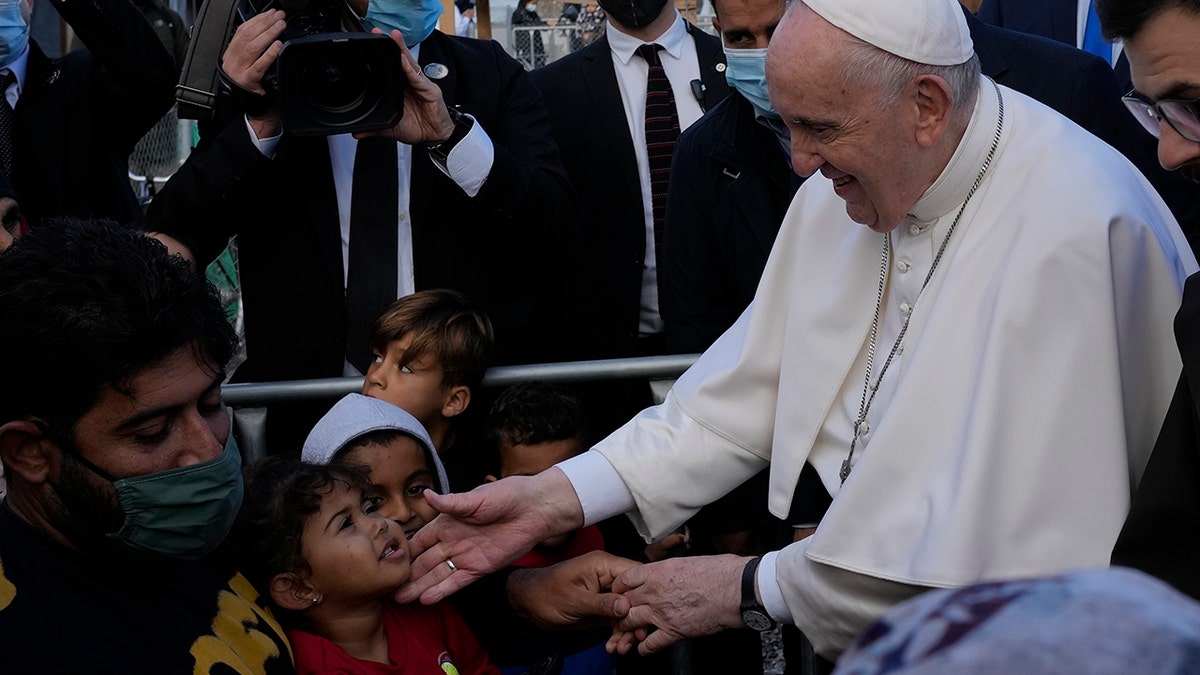 Pope Francis meets migrants during his visit at the Karatepe refugee camp, on the northeastern Aegean island of Lesbos, Greece