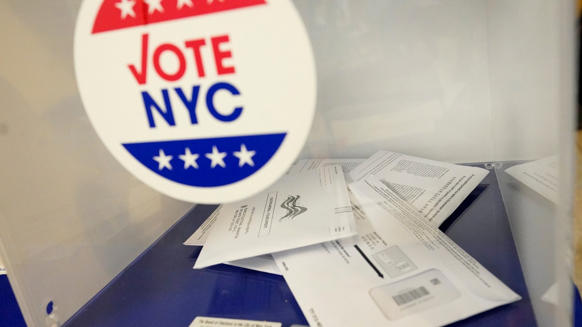 Absentee ballots sit in a ballot box during early voting in the primary election, Monday, June 14, 2021, at the Church of St. Anthony of Padua in the Soho neighborhood of New York. New York City, long a beacon for immigrants, is on the cusp of becoming the largest place in the U.S. to give noncitizens the right to vote. Legally documented, voting-age noncitizens, who comprise nearly one in 10 of the city's 8.8 million inhabitants, would be allowed to cast votes in elections to pick the mayor, City Council members and other municipal officeholders under a bill nearing approval.(AP Photo/Mary Altaffer, File)