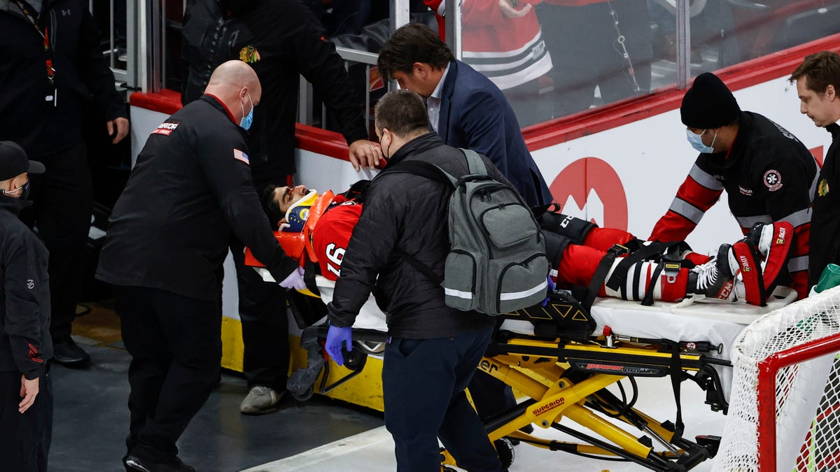 Chicago Blackhawks center Jujhar Khaira (16) leaves the ice on a stretcher after being knocked out by New York Rangers defenseman Jacob Trouba during the second period of an NHL hockey game, Tuesday, Dec. 7, 2021, in Chicago. 