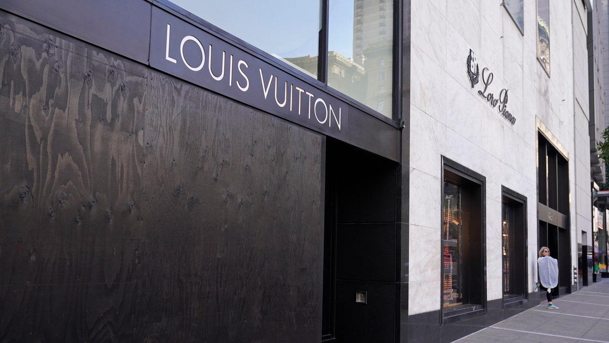 A large window of the Louis Vuitton store is seen boarded up following a recent robbery at Union Square in San Francisco. (AP Photo/Eric Risberg)