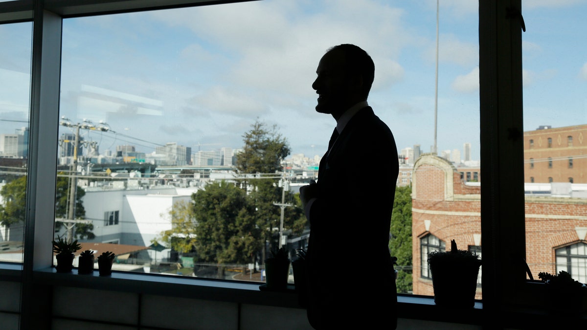 FILE - San Francisco District Attorney Chesa Boudin is silhouetted looking out at the skyline from his office in San Francisco on Jan. 30, 2020. (AP Photo/Eric Risberg, File)