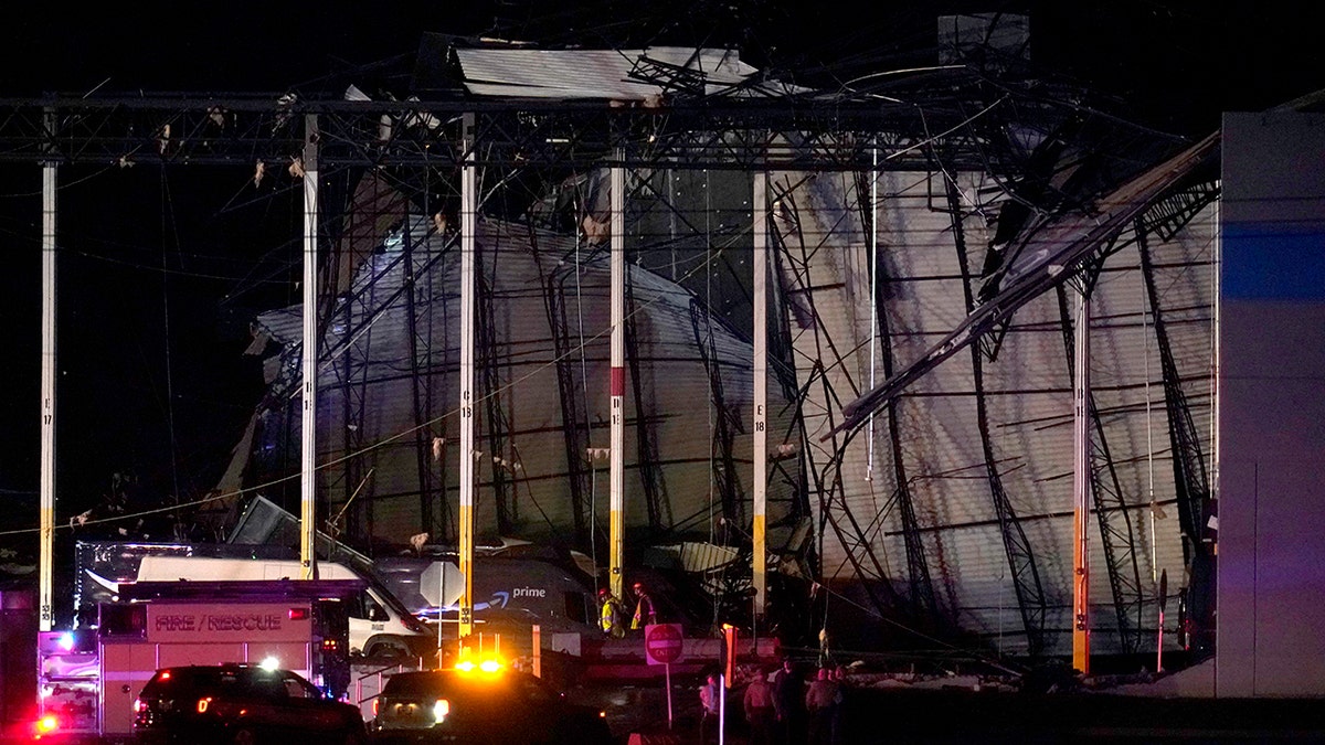 First responders work outside an Amazon fulfillment center after it was heavily damaged when a strong thunderstorm moved through the area Friday, Dec. 10, 2021, in Edwardsville, Illinois.