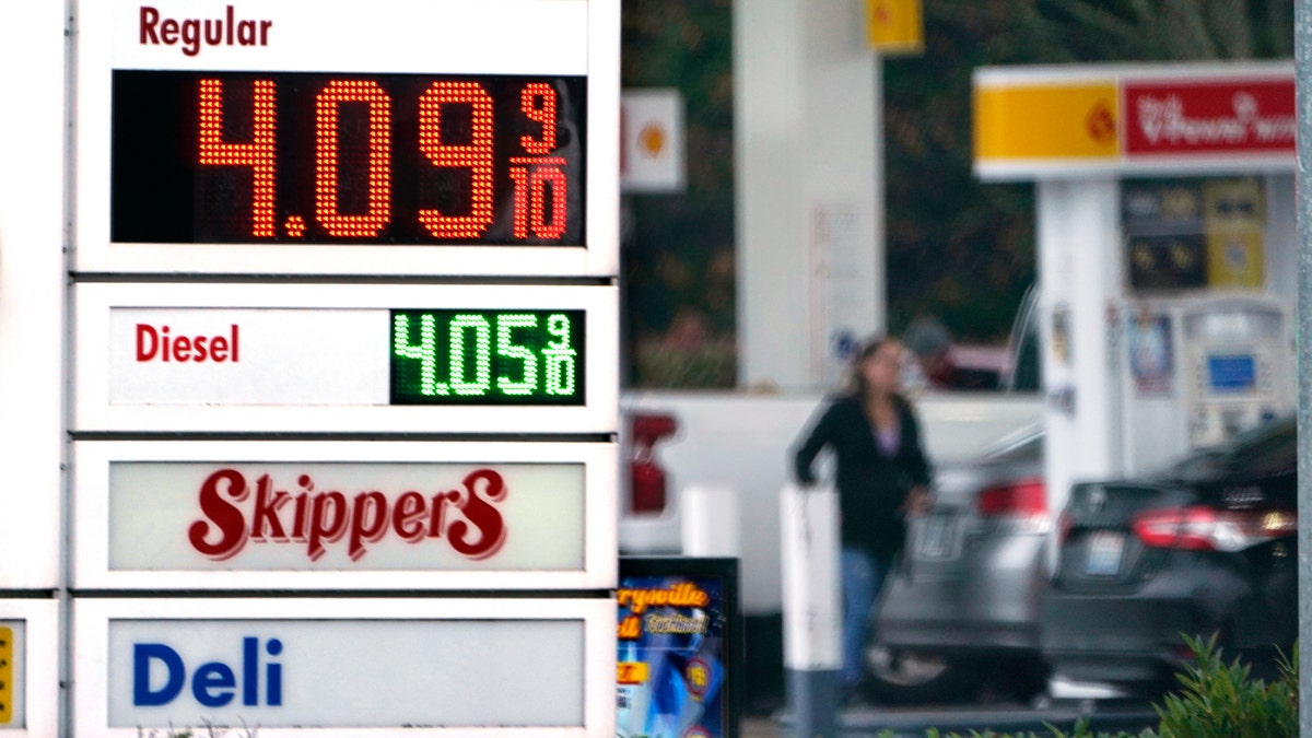 A driver fills up at a gas station on Dec. 10, 2021, in Marysville, Washington. (AP Photo/Elaine Thompson, File)