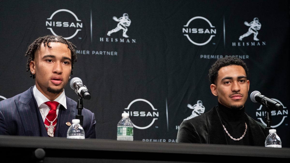 Heisman Trophy finalists Ohio State quarterback C.J. Stroud, left, speaks alongside Alabama quarterback Bryce Young during a news conference (AP Photo/John Minchillo)