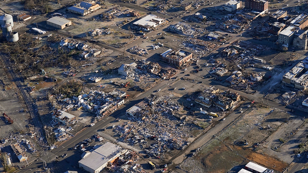 In this aerial photo, a collapsed factory and surrounding areas are seen in Mayfield, Ky., Sunday, Dec. 12, 2021.  (AP Photo/Gerald Herbert)