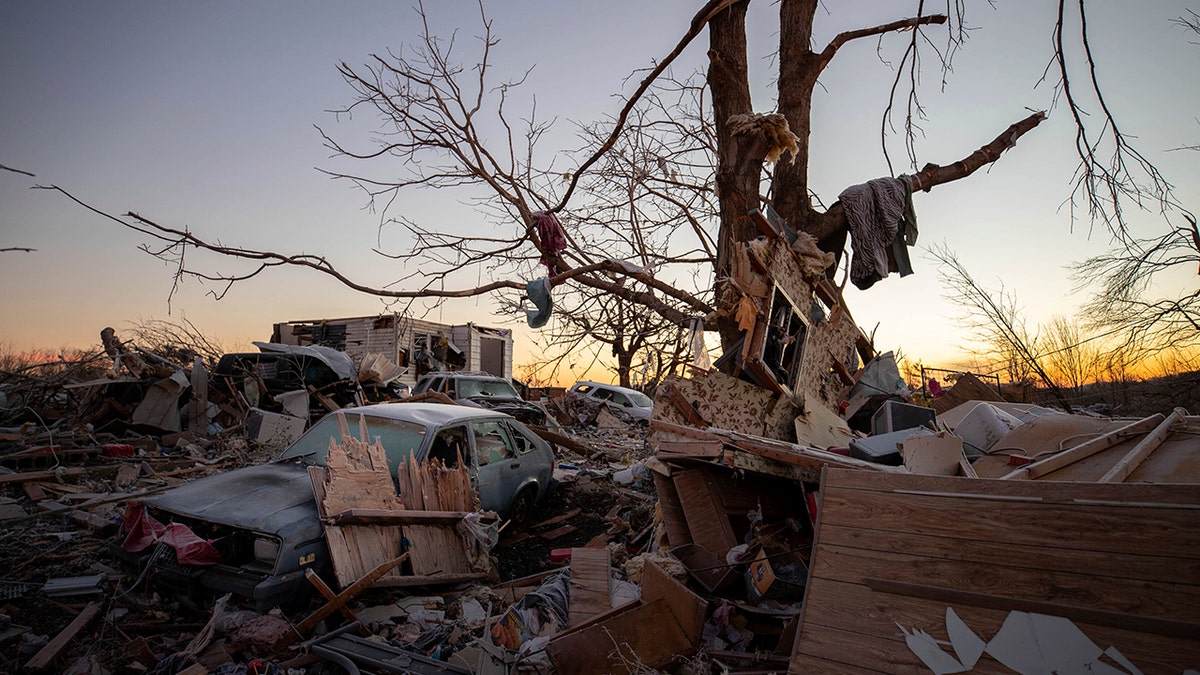 A car sits among the remains of a destroyed house after a tornado in Dawson Springs, Kentucky