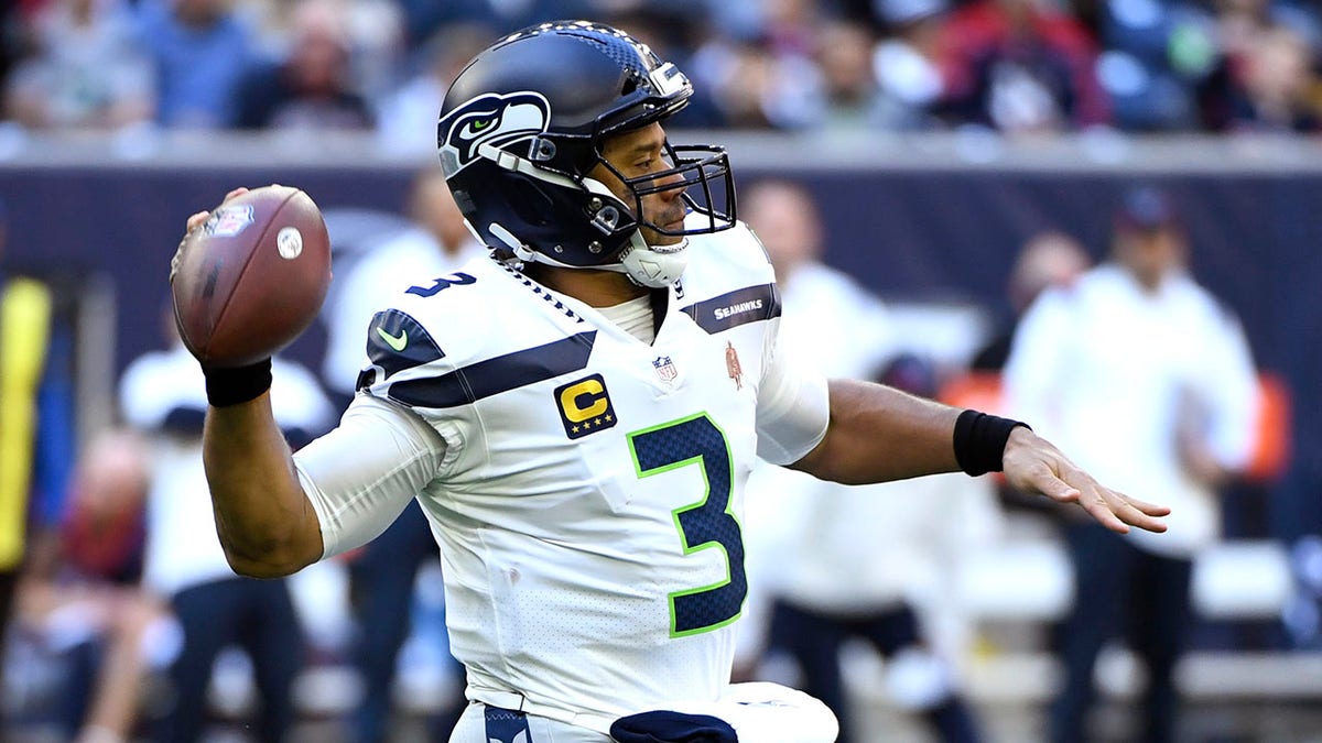 Seattle Seahawks quarterback Russell Wilson (3) throws against the Houston Texans during the first half of an NFL football game, Sunday, Dec. 12, 2021, in Houston.