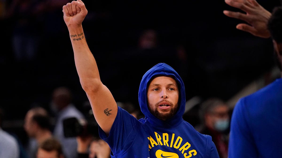 Golden State Warriors guard Stephen Curry gestures as he warms up before an NBA basketball game against the New York Knicks, Tuesday, Dec. 14, 2021, at Madison Square Garden in New York.