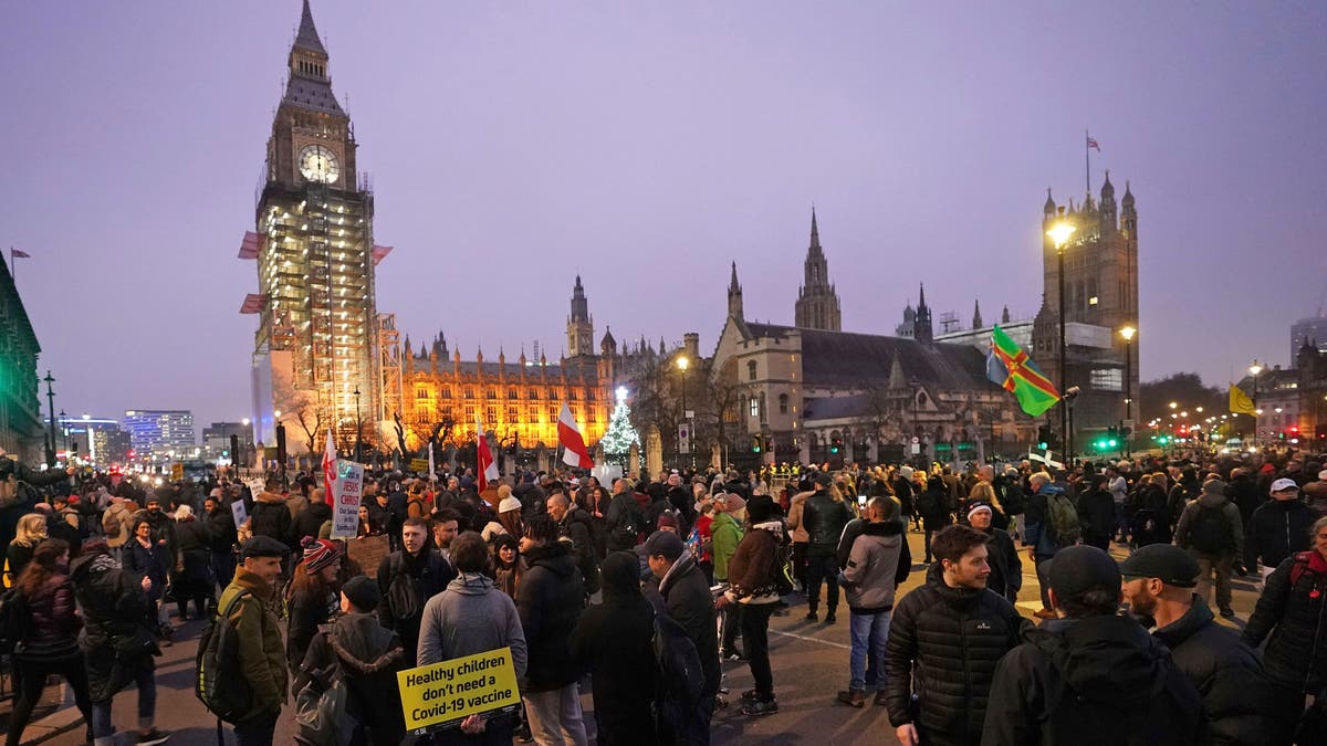Anti -COVID-19 vaccination protesters demonstrate on Parliament Square in London, Saturday, Dec. 18, 2021. (Ian West/PA via AP)