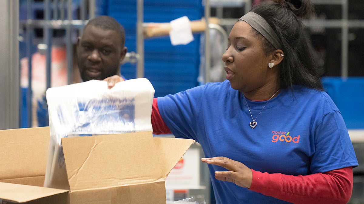 In this 2018 photo provided by Holt Haynsworth, Portia Thomas packs boxes at the Food For Good Warehouse in Austin, Texas in 2018. (Holt Haynsworth via AP)