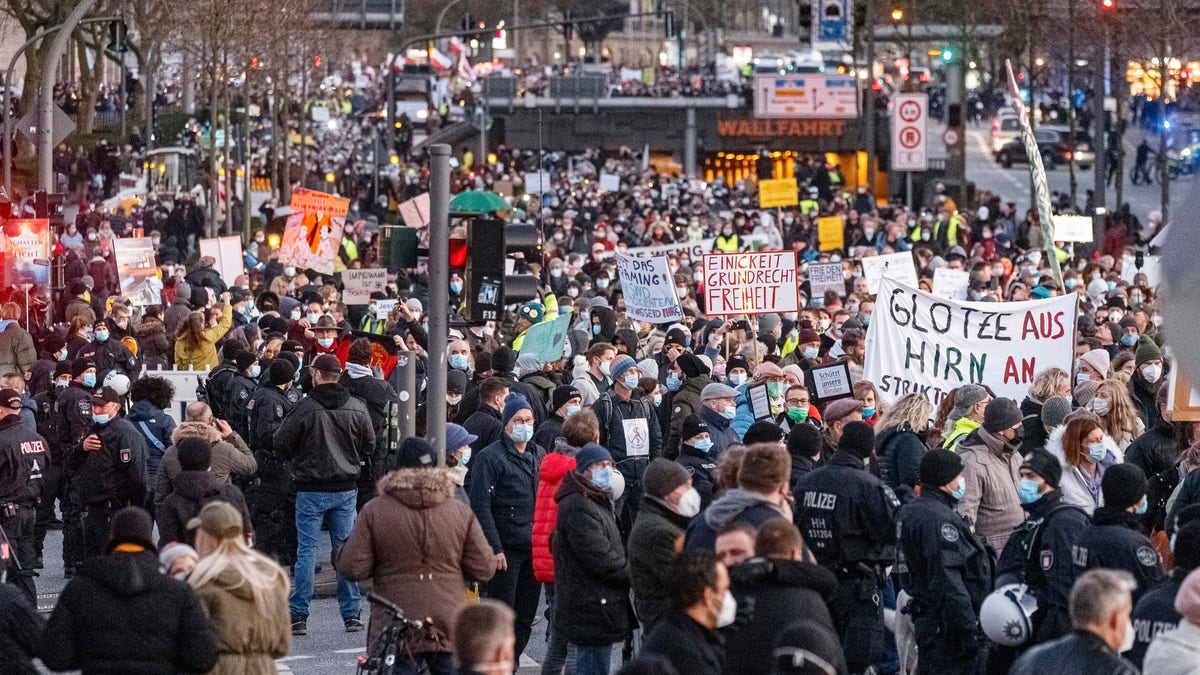 Participants gather to demonstrate against COVID-19 measures in downtown Hamburg, Saturday Dec. 18, 2021. (Markus Scholz/dpa via AP)