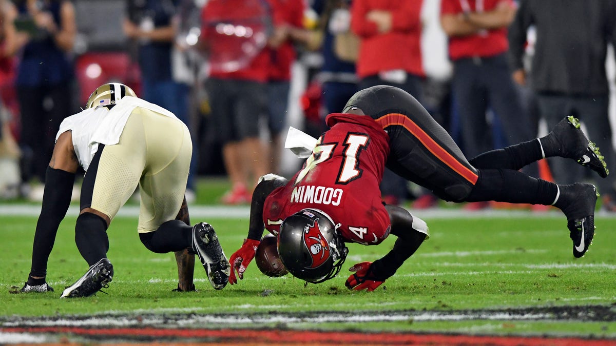 Tampa Bay Buccaneers wide receiver Chris Godwin (14) can't hang onto a pass after getting hit by New Orleans Saints cornerback P.J. Williams (26) during the first half of an NFL football game Sunday, Dec. 19, 2021, in Tampa, Fla.