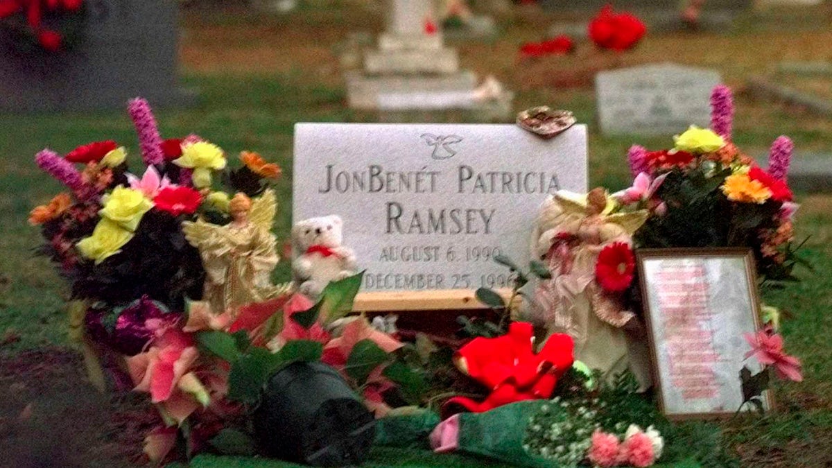 Flowers, pictures and stuffed animals adorn the gravesite of JonBenet Patricia Ramsey on Dec. 26, 1997, at the St. James Episcopal Church Cemetery in Marietta, Ga. (AP Photo/Ric Feld, File)