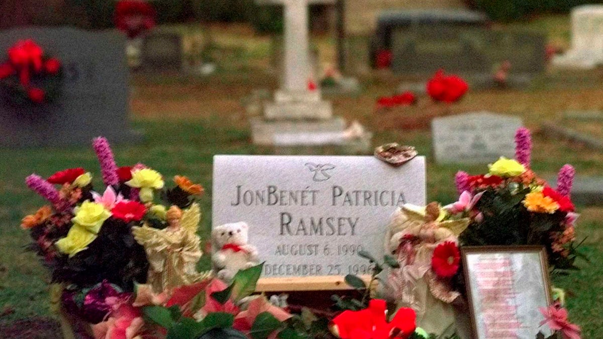 Flowers, pictures and stuffed animals adorn the gravesite of JonBenet Patricia Ramsey on Dec. 26, 1997, at the St. James Episcopal Church Cemetery in Marietta, Ga. (AP Photo/Ric Feld, File)