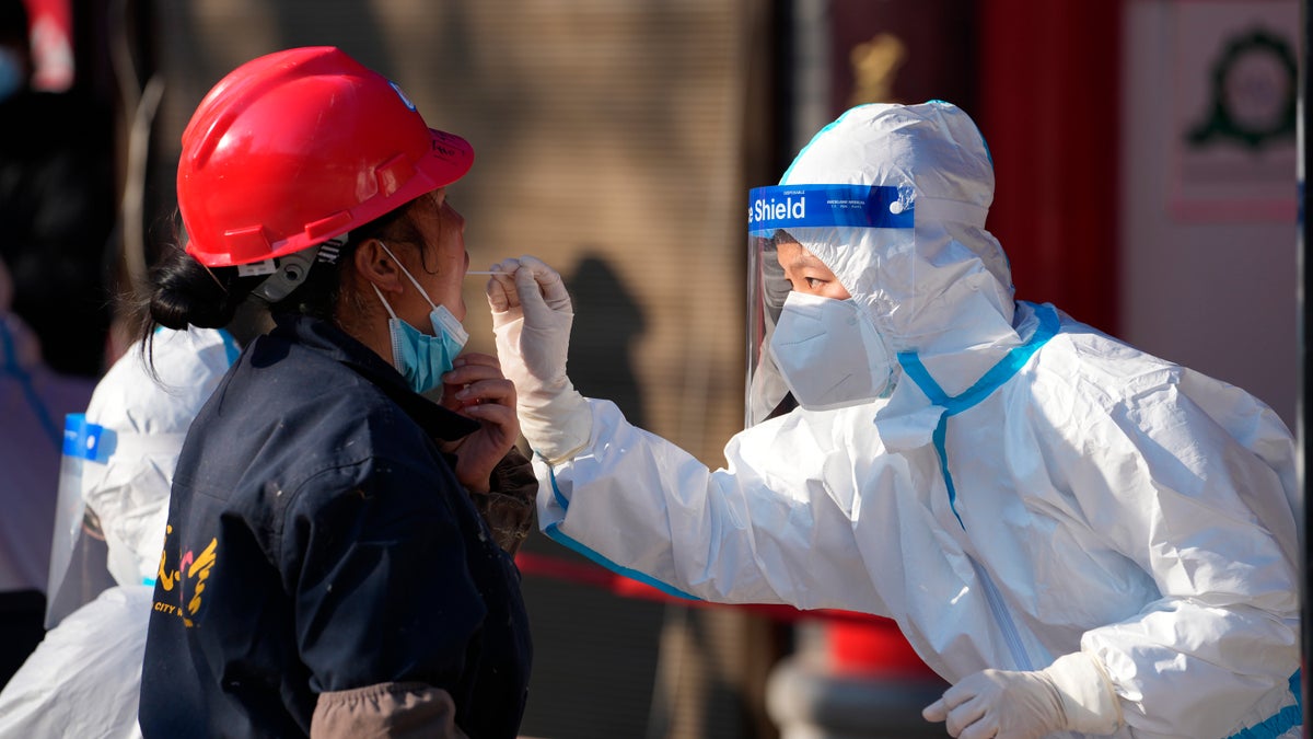 photo of worker testing person for coronavirus