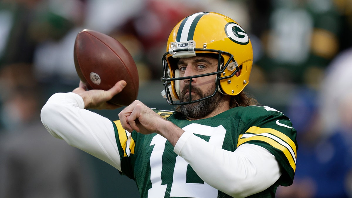 Green Bay Packers' Aaron Rodgers warms up before an NFL football game against the Cleveland Browns Saturday, Dec. 25, 2021, in Green Bay, Wis.