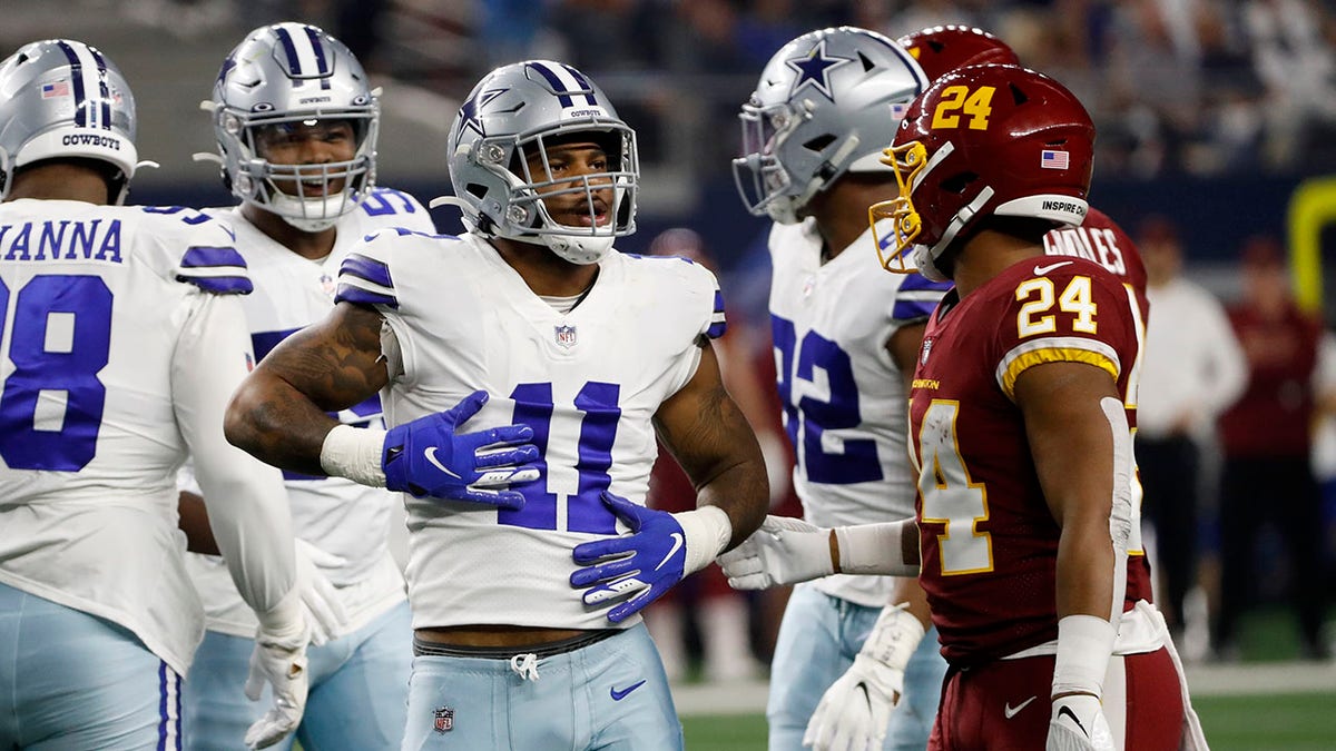 Dallas Cowboys outside linebacker Micah Parsons (11) celebrates in front of Washington Football Team running back Antonio Gibson (24) after sacking quarterback Taylor Heinicke (4) in the first half of an NFL football game in Arlington, Texas, Sunday, Dec. 26, 2021. (AP Photo/Roger Steinman)