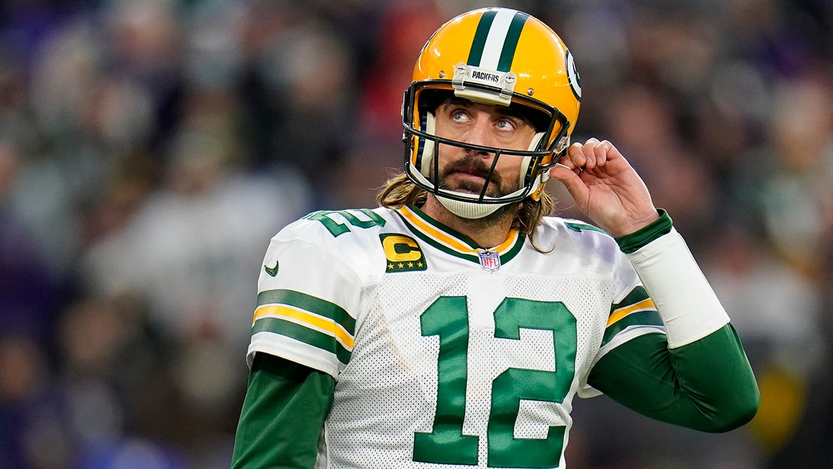 Green Bay Packers quarterback Aaron Rodgers walks off the field after not being able to convert for a first down in the first half of an NFL football game against the Baltimore Ravens, Sunday, Dec. 19, 2021, in Baltimore.