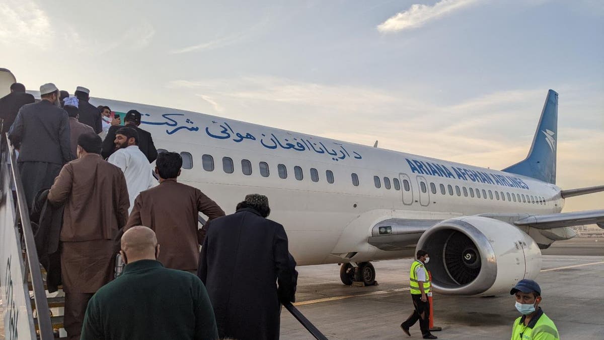 Evacuees from Afghanistan board plane. Courtesy of Project DYNAMO