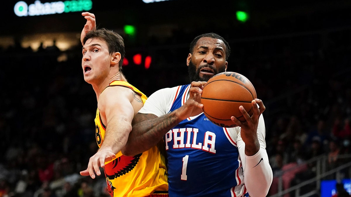 Philadelphia 76ers center Andre Drummond (1) pulls down a rebound in front of Atlanta Hawks forward Danilo Gallinari (8) during the second half Friday, Dec. 3, 2021, in Atlanta.