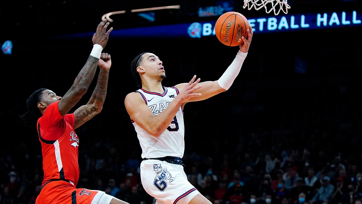Gonzaga guard Andrew Nembhard, right, goes up for a shot against Texas Tech guard Davion Warren, left, during the first half of an NCAA college basketball game at the Jerry Colangelo Classic Saturday, Dec. 18, 2021, in Phoenix.