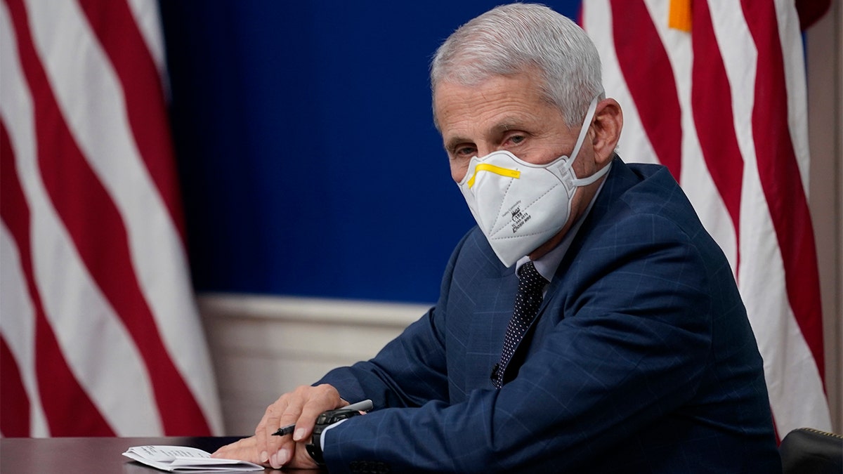 Dr. Anthony Fauci, the top U.S. infectious disease expert, wears a face mask during the White House COVID-19 Response Team's regular call with the National Governors Association in the South Court Auditorium in the Eisenhower Executive Office Building on the White House Campus, Monday, Dec. 27, 2021, in Washington. (AP Photo/Carolyn Kaster)