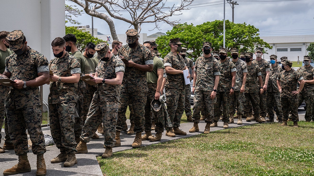 KIN, JAPAN - APRIL 28: United States Marines queue to receive the Moderna coronavirus vaccine at Camp Hansen on April 28, 2021 in Kin, Japan. A United States military vaccination program aiming to inoculate all service personnel and their families against Covid-19 coronavirus is under way on Japans southernmost island of Okinawa, home to around 30,000 US troops and one of the largest US Marine contingents outside of mainland USA. (Photo by Carl Court/Getty Images)