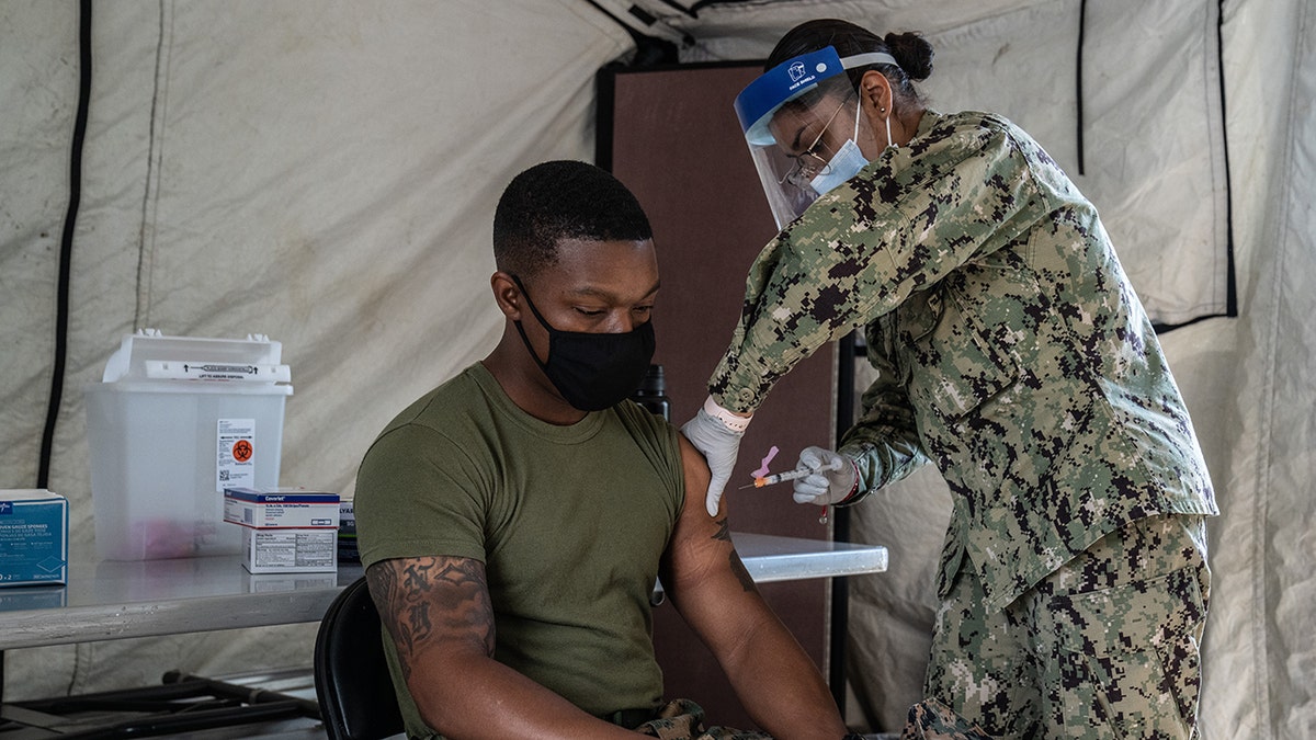GINOWAN, JAPAN - APRIL 28: A United States Marine receives the Moderna coronavirus vaccine at Camp Foster on April 28, 2021 in Ginowan, Japan. A United States military vaccination program aiming to inoculate all service personnel and their families against Covid-19 coronavirus is under way on Japans southernmost island of Okinawa, home to around 30,000 US troops and one of the largest US Marine contingents outside of mainland USA. (Photo by Carl Court/Getty Images)