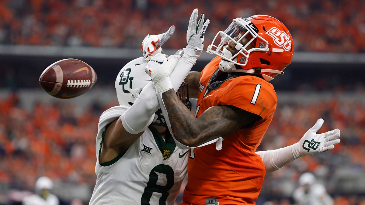 Tay Martin (1) of the Oklahoma State Cowboys has a pass in the end zone knocked away by Jalen Pitre (8) of the Baylor Bears in the first half of the Big 12 Football Championship Dec. 4, 2021 in Arlington, Texas.