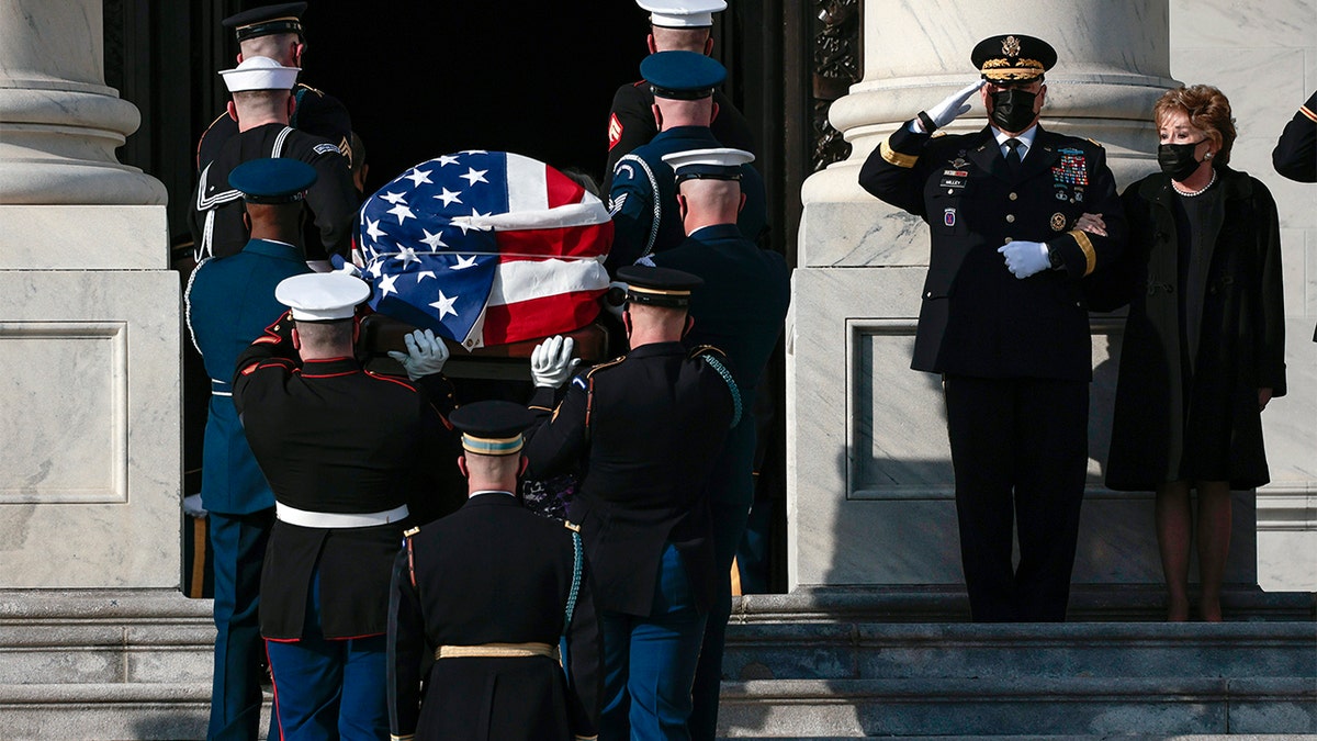 Elizabeth Dole watches as a joint services military bearer team moves the casket of her husband former Sen. Bob Dole, R-Kan., during arrival at the U.S. Capitol, where he will lie in state in the Rotunda, Thursday Dec. 9, 2021, on Capitol Hill in Washington.