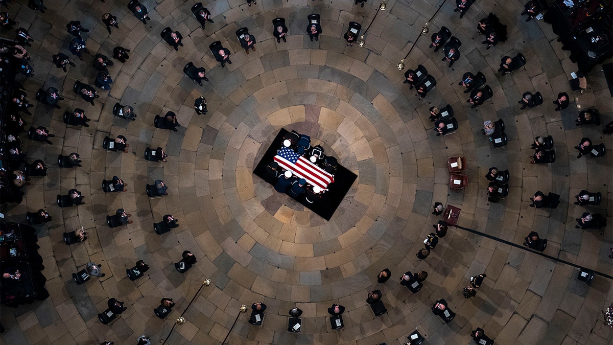 The casket of former Sen. Bob Dole, R-Kan., arrives in the Rotunda of the U.S. Capitol, where he will lie in state, Thursday, Dec. 9, 2021, on Capitol Hill in Washington. 