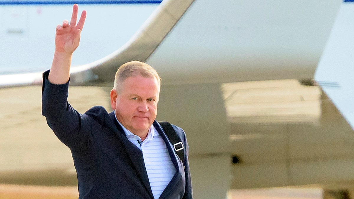 New LSU football coach Brian Kelly gestures to fans after his arrival at Baton Rouge Metropolitan Airport, Tuesday, Nov. 30, 2021, in Baton Rouge, La. Kelly, formerly of Notre Dame, is said to have agreed to a 10-year contract with LSU worth $95 million plus incentives.  