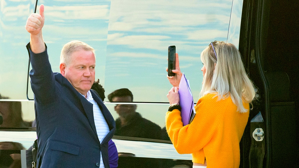 New LSU football coach Brian Kelly gestures to fans after his arrival at Baton Rouge Metropolitan Airport, Tuesday, Nov. 30, 2021, in Baton Rouge, La. Kelly, formerly of Notre Dame, is said to have agreed to a 10-year contract with LSU worth $95 million plus incentives. 