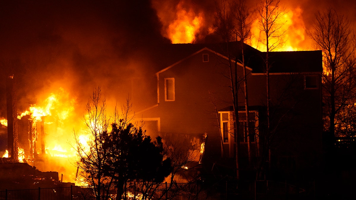 Homes burn as wildfires rip through a development Thursday, Dec. 30, 2021, in Superior, Colorado.